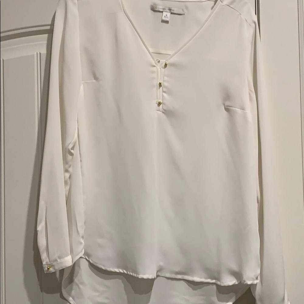 100%polyester; longer length in back;darts.